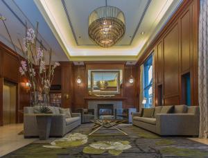a lobby with couches and a fireplace and a chandelier at The Magnolia Hotel & Spa in Victoria