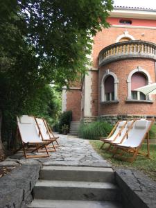 a group of chairs sitting in front of a building at Rooms Portorose Center in Portorož