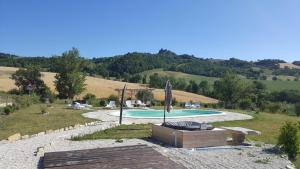a swimming pool in the middle of a field at Agriturismo Dai Du Bourdei in Frontino