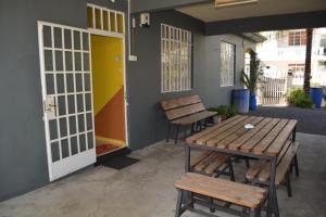 a patio with a wooden table and chairs next to a door at Apartment Nashou in Grand Baie