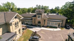 an aerial view of a large house with a parking lot at Puddicombe House in New Hamburg