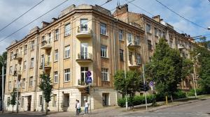 a large building on the corner of a street at M.K. Apartments in Vilnius