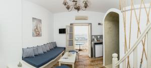 a living room with a couch and a table at Viva Mare Traditional Studios in Astypalaia