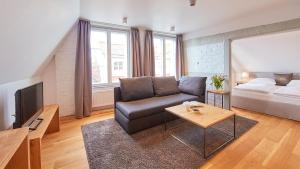 a living room with a couch and a bed at Anno 1433 Hotel Lüneburg in Lüneburg