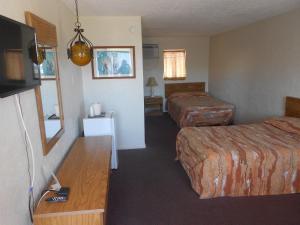 a hotel room with two beds and a flat screen tv at Viking Motel in Wildwood Crest