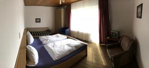 a small bedroom with a bed and a window at Dribischenhof in Willingen