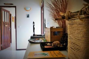 a room with a table with a statue of a woman at Casa D'Mar in Ponta do Sol