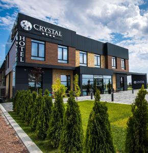 a building with trees in front of it at Hotel Crystal in Pećinci