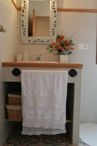 a bathroom with a sink with a white towel on it at Apartamentos Rurales La Carbayala in Oviñana