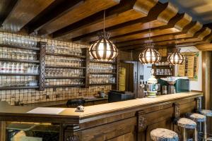 a bar with wooden walls and chandeliers at Pension zum Meridianstein in Gmünd