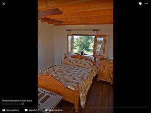 a bedroom with a bed and a dresser and a window at Amalia Panorama House in Zanaja