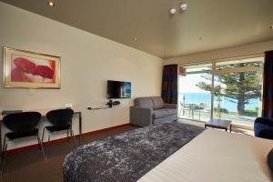 a hotel room with a bed and a view of the ocean at The White Morph - Heritage Collection in Kaikoura