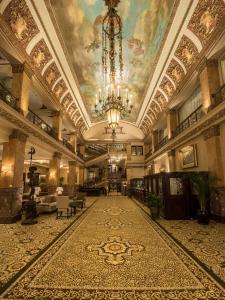 a large lobby with a ceiling with a chandelier at The Pfister Hotel in Milwaukee