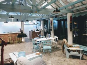 a dining room with a table and chairs and lights at Pousada Eldorado Guarujá - in Guarujá