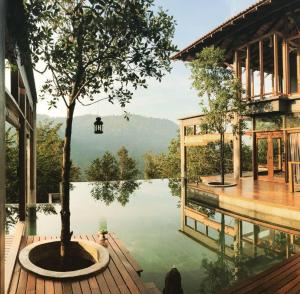 a pool with a tree in the middle of a building at The Shorea in Seremban