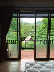an open glass door with a view of a mountain at Thai Terrace Bungalow in Thong Nai Pan Yai