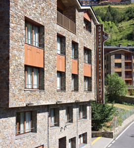 a brick building with windows on the side of it at Apartaments Sant Bernat in Canillo