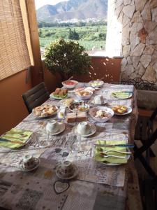 a table with plates of food on top of it at La Pavoncella in Villaputzu