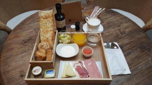 
a wooden table topped with a tray filled with food at Palacio Carvajal Girón in Plasencia
