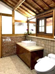 a bathroom with a sink and a toilet at Bamboo House in Zhushan