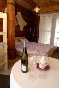 a bottle of wine sitting on a table with two wine glasses at U Srubu Sychrov in Sychrov