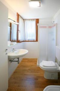a bathroom with a sink and a toilet and a shower at Country House Letizia in Ca' di David