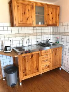 a kitchen with wooden cabinets and a counter top at Ferienwohnung Schlössershof in Borler