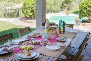a wooden table with food on top of it at Country Domos Tramentu in Ozieri