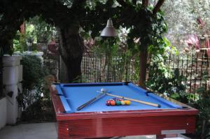 a pool table with two paddles and balls on it at Navy Hotel in Marmaris