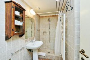 a bathroom with a sink and a shower at Scipioni Suites in Rome