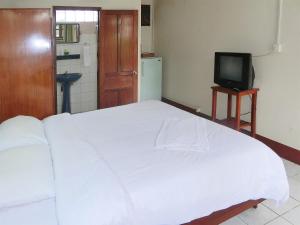 En eller flere senge i et værelse på Villa Sisavad Guesthouse