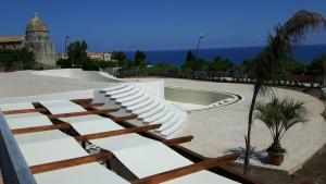 a amphitheater with white seats and a skate park at Villa Oscar in Tropea