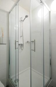 a shower with a glass door in a bathroom at Delightful studio in the Center of Amsterdam in Amsterdam