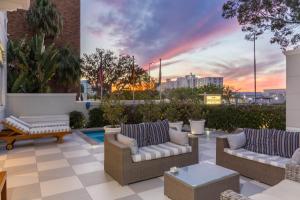 a rooftop patio with couches and a sunset at Head South Lodge in Cape Town