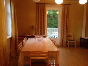 a dining room with a table and chairs and a window at Sae Hostel in Võsu