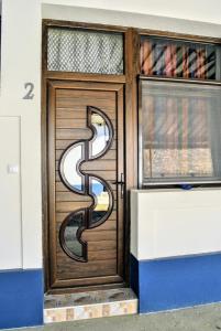 a wooden door with a letter b on it at Eco Rural Tourism Association Skorenovac in Skorenovac