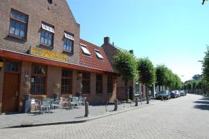 a brick building with chairs and tables on a street at Hotel Cafe 't Zonneke in Oosterhout