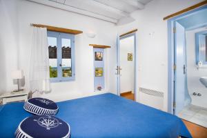 クリシ・アクティにあるVilla Yviskos Traditional Homeのベッドルーム1室(青いベッド1台、枕2つ付)
