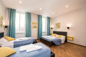 ローマにあるSeven Rooms Vaticanのホテルルーム(ベッド2台、青いカーテン付)