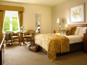 a hotel room with a bed and a table and chairs at Kilmurry Lodge Hotel in Limerick