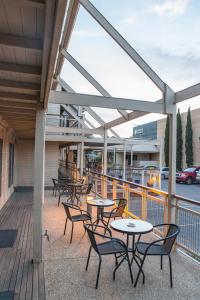 a group of tables and chairs on a deck at The River Boat Hotel - Echuca in Echuca