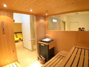 a room with a sauna with a bench and a mirror at Parkhotel Kirchberg in Kirchberg in Tirol