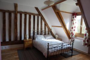 a bedroom with a bed in a attic at Maison du Murphy in Sourdeval