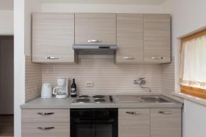 a small kitchen with a stove and a sink at Apartment Kod Jadranke in Šipanska Luka