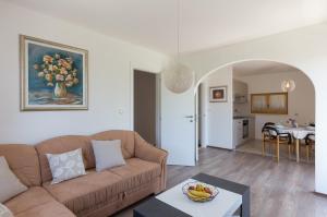 a living room with a couch and a table at Apartment Kod Jadranke in Šipanska Luka