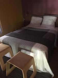 a bedroom with two beds and a stool at Villa Cemaste in Montpellier