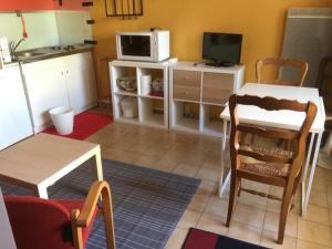 a small kitchen with a table and a microwave at Villa Cemaste in Montpellier