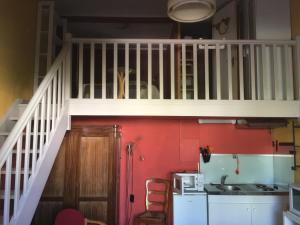 a kitchen with a staircase with a sink and a microwave at Villa Cemaste in Montpellier