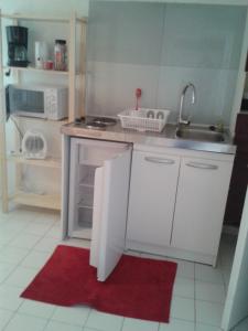a kitchen with a sink and an open refrigerator at Villa Cemaste in Montpellier