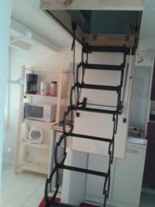 a ladder in a kitchen with a refrigerator at Villa Cemaste in Montpellier